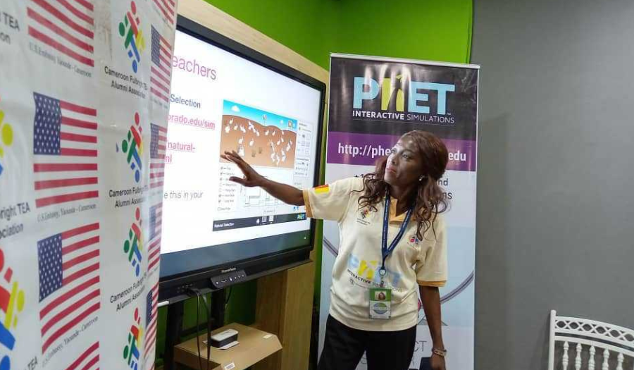A teacher points to the National Selection simulation as she presents to the class.